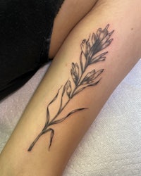 a black and white tattoo of a flower