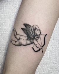 a tattoo of a cupid with a bow and arrow